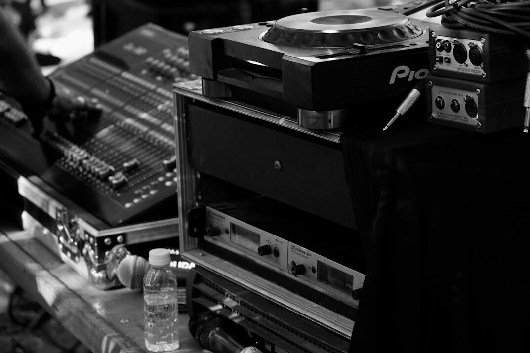 Audio and video mixing desk with sliders and screens